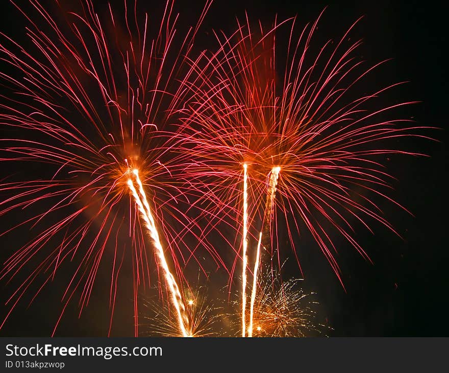 Large fireworks exploding high in the air in different colours