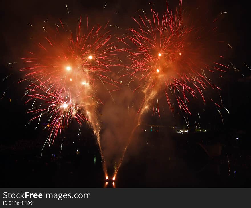 Large fireworks exploding high in the air in different colours