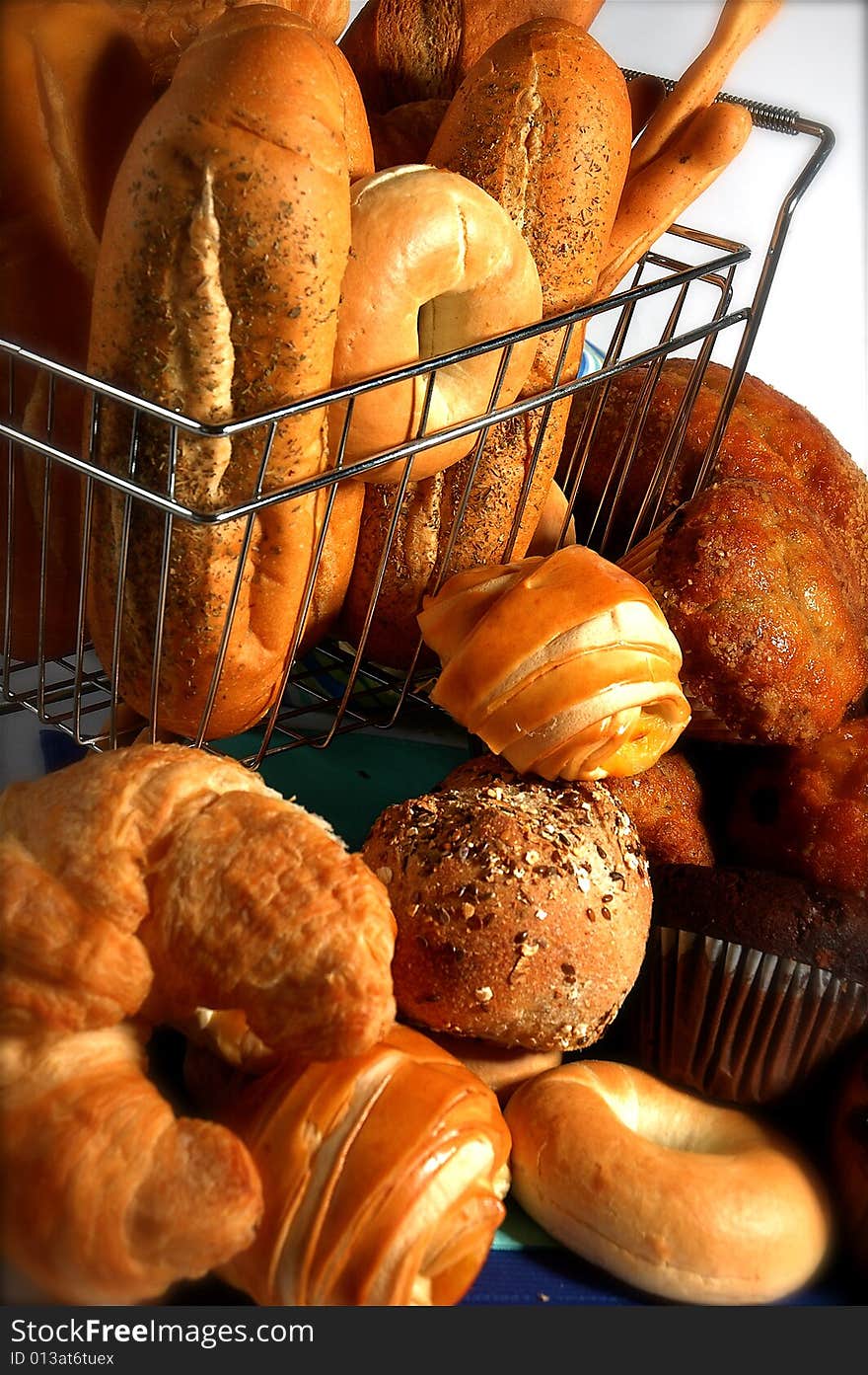 Small grocery cart with various breads inside. Small grocery cart with various breads inside