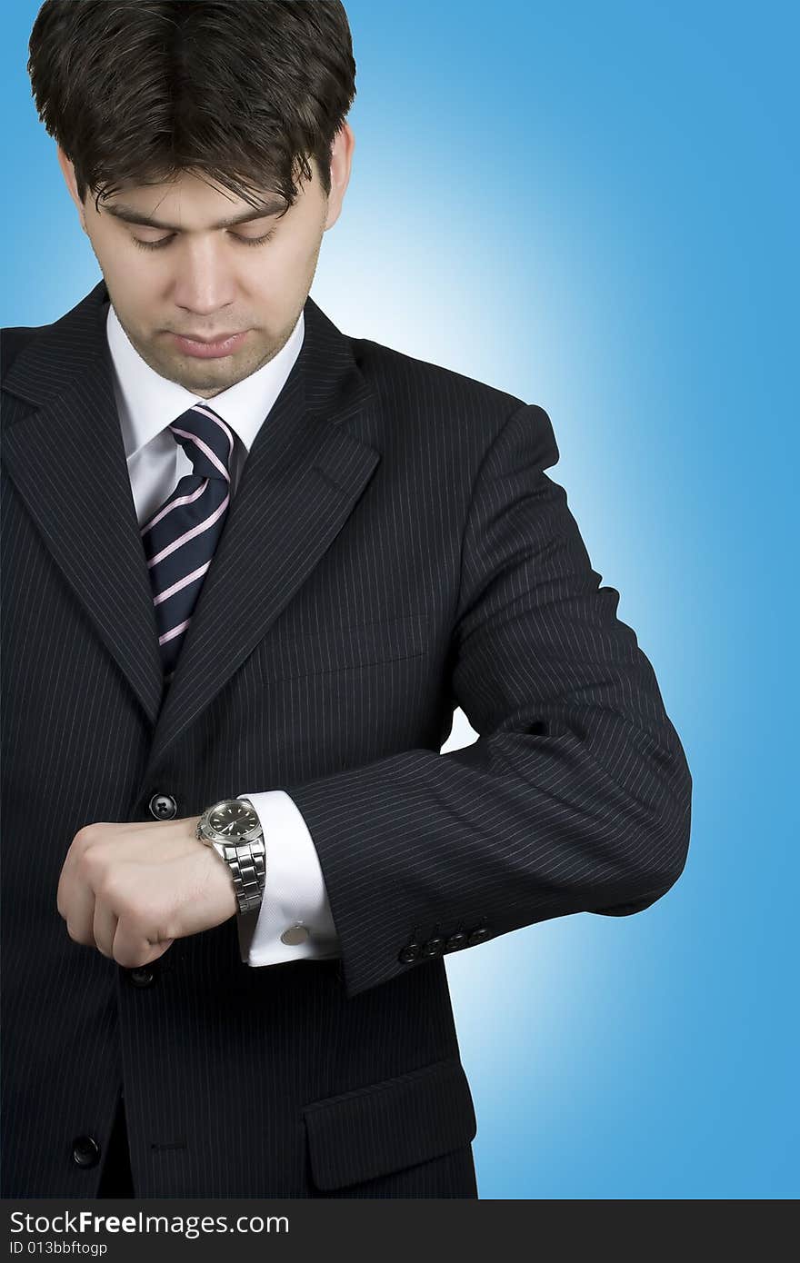 Handsome businessman looking at the watch. Handsome businessman looking at the watch