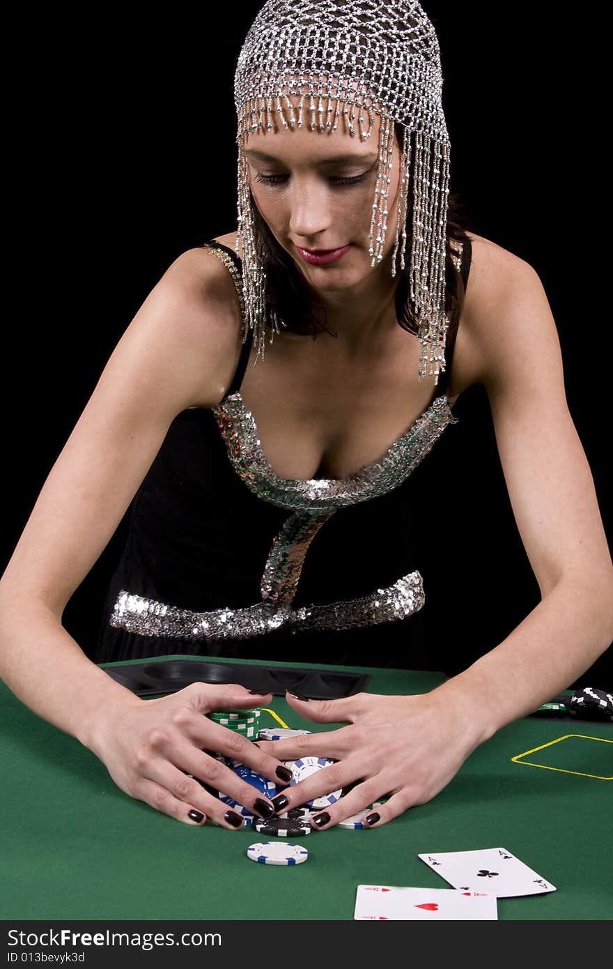 Attractive brunette woman colleting her winnings at the poker table. Attractive brunette woman colleting her winnings at the poker table