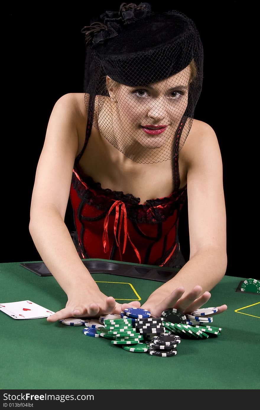 Attractive blond woman betting all her chips in a game of poker. Attractive blond woman betting all her chips in a game of poker