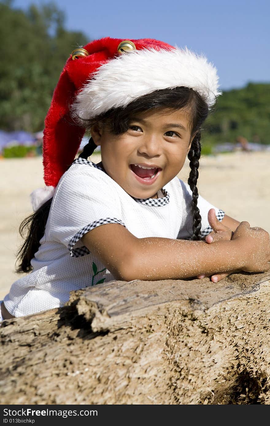 Thai Girl With Christmas Hat On Beach