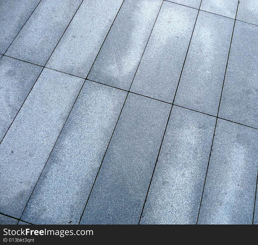 A photograph of some rectangle pavement slabs. A photograph of some rectangle pavement slabs.