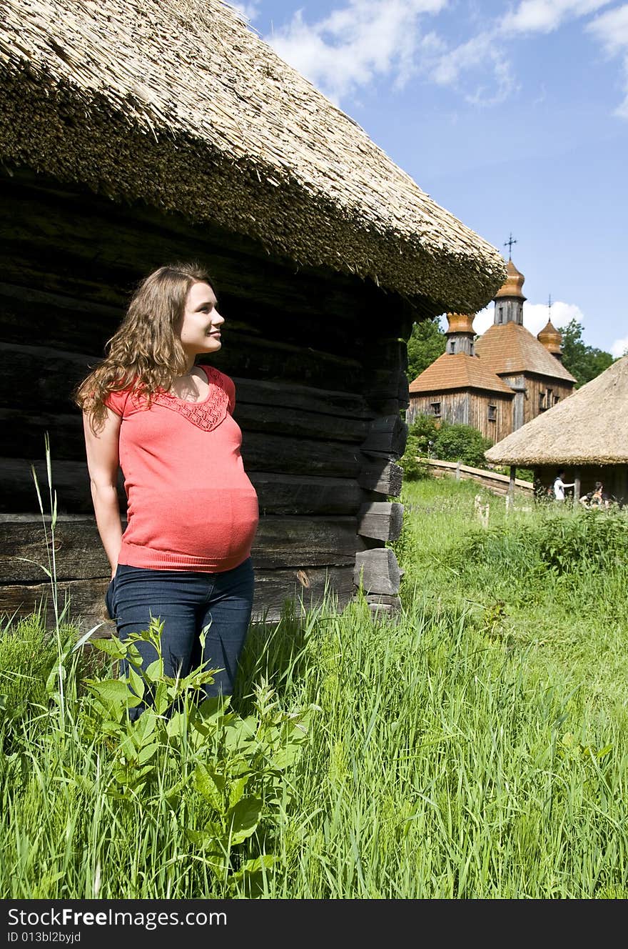 A pregnant woman looks at a church