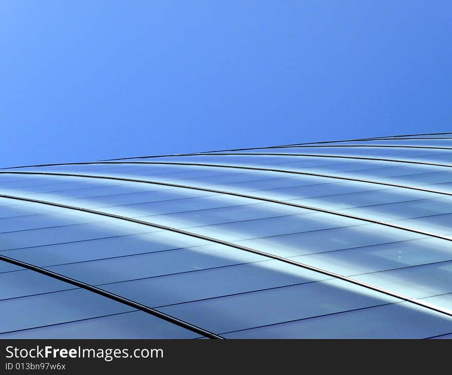 An abstract view of the glass windows of a modern building. An abstract view of the glass windows of a modern building.