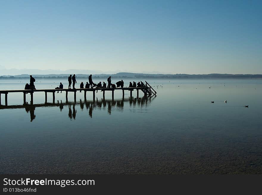 People on a footbridge (morning, Starnberger lake, Bavaria, Germany)