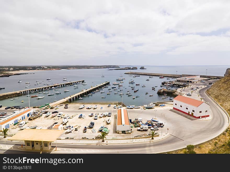 Port facility full of boats under cloudscape