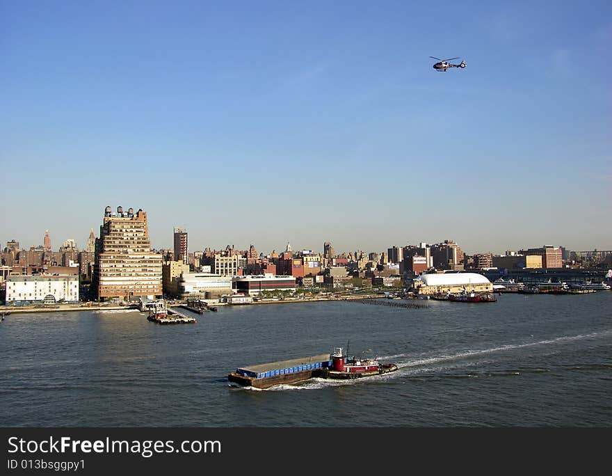 Busy traffic on a water and in the air in Manhattan, New York City. Busy traffic on a water and in the air in Manhattan, New York City.