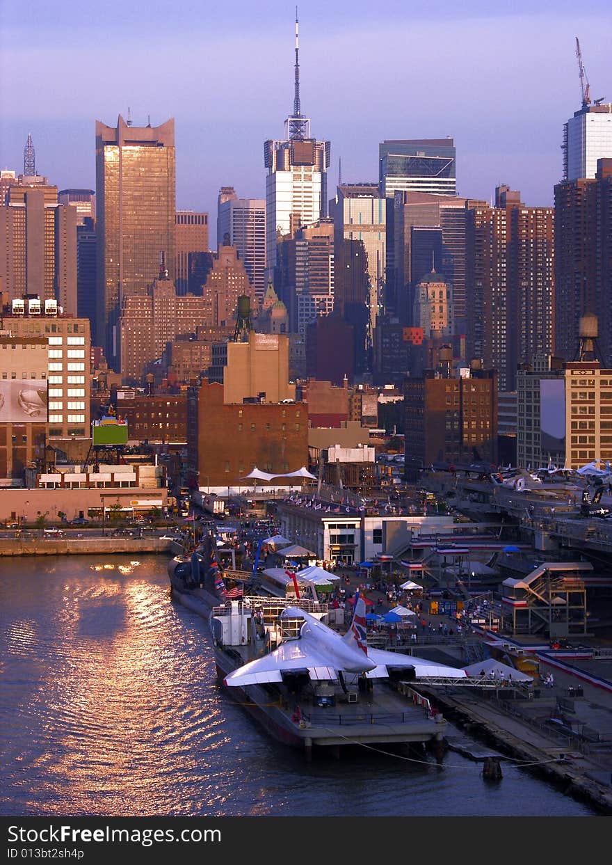 The view of military plane and Manhattan skyscrapers in sunset light (New York City).