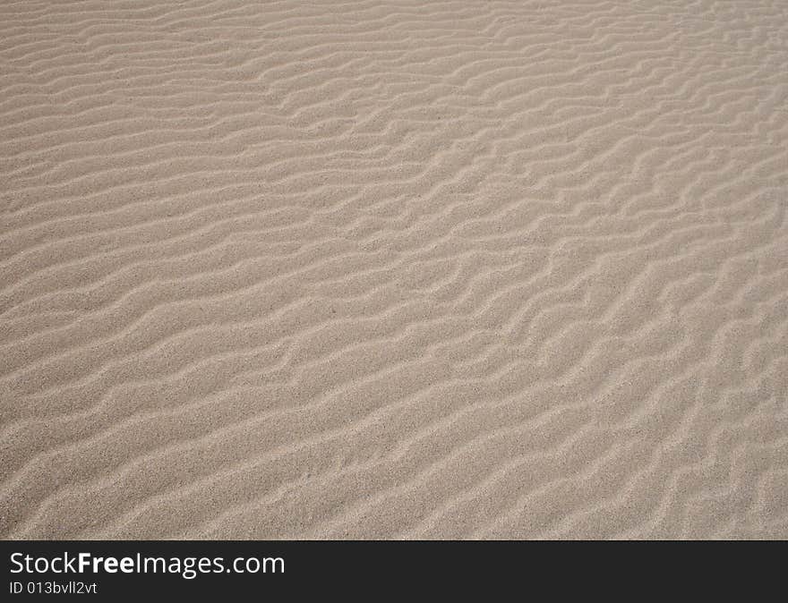 Wave patterns on a sand beach. Wave patterns on a sand beach.