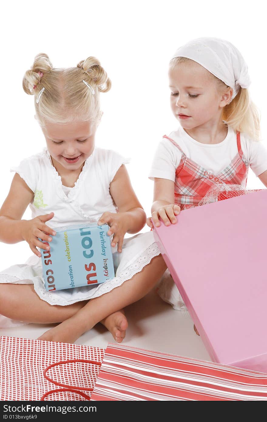 Two cute girls celebrating special occasion, unpacking gifts together