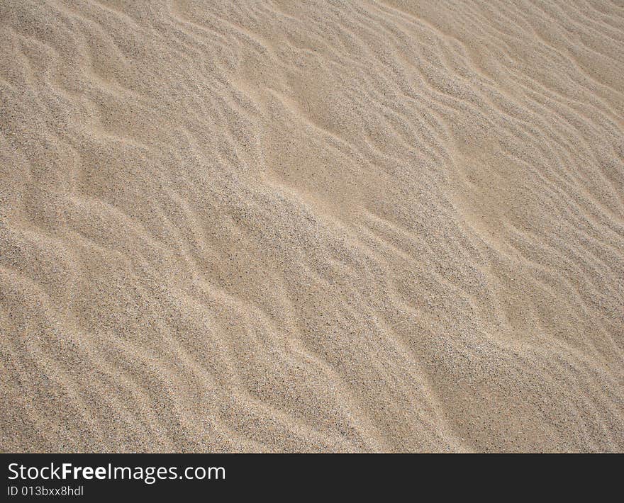 Wave patterns on a sand beach. Wave patterns on a sand beach.