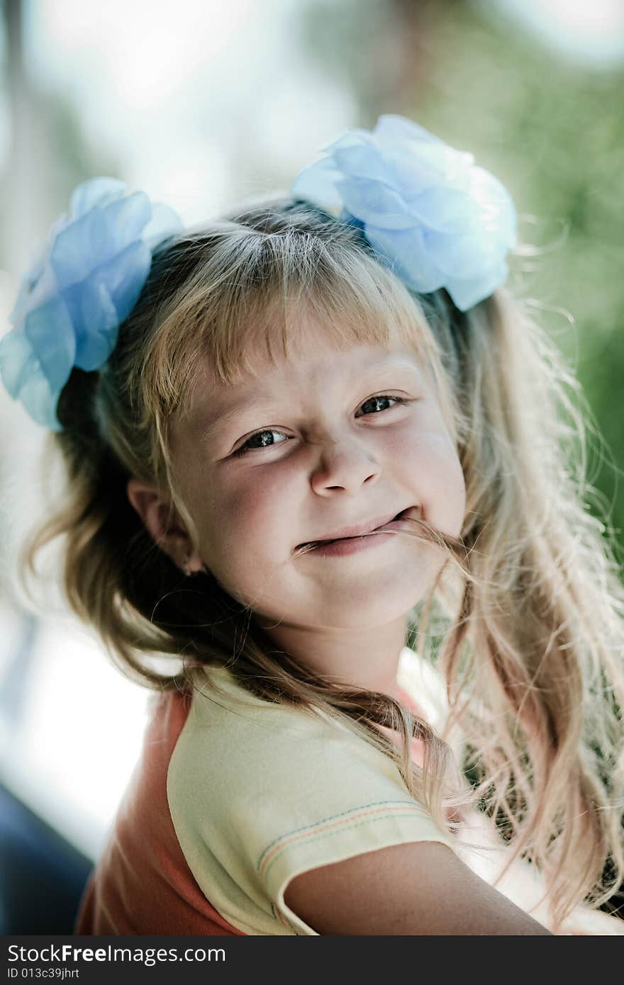 An image of smiling girl. On blurred background