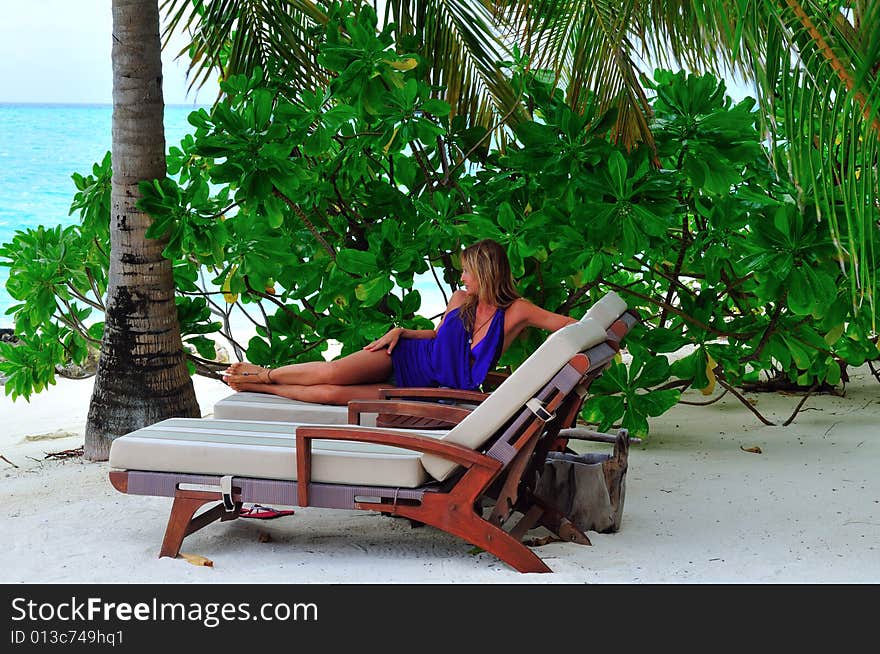 Woman lying on chaise longue