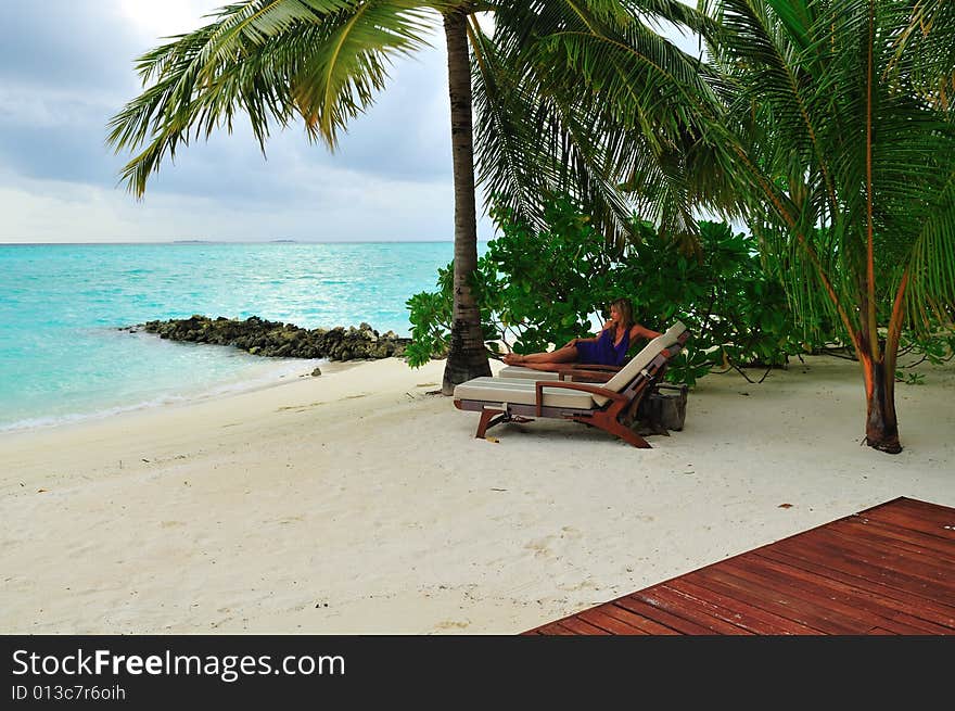 Woman lying on chaise longue