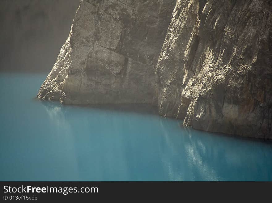 Huge vertical rock wall above the lake. Huge vertical rock wall above the lake