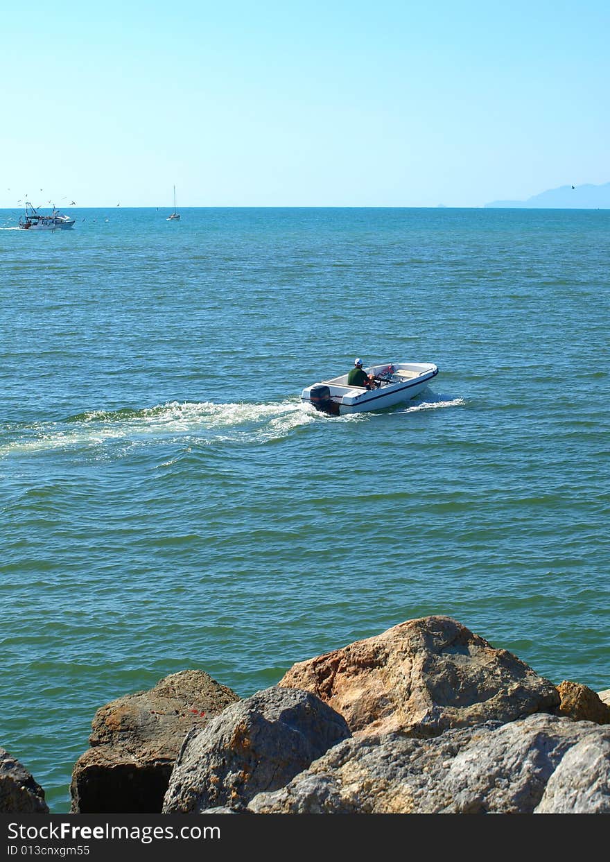 A suggestive shot of a boat that leaves the port of Viareggio. A suggestive shot of a boat that leaves the port of Viareggio