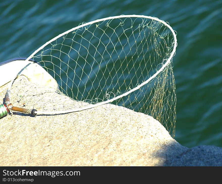 An original shot of a fishing net on a rock waiting for the fishes