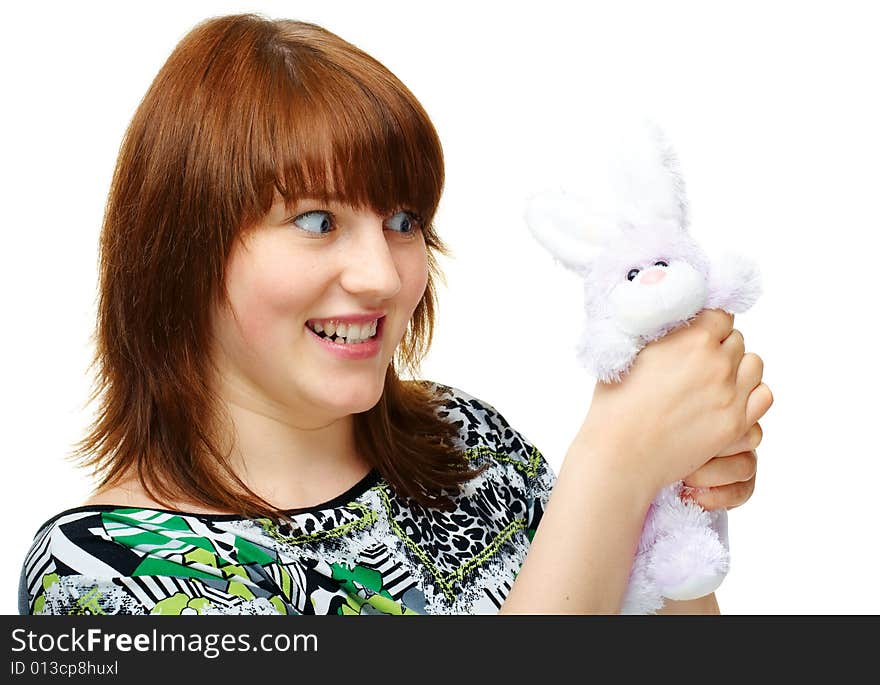 Angry young girl with toy bunny over white