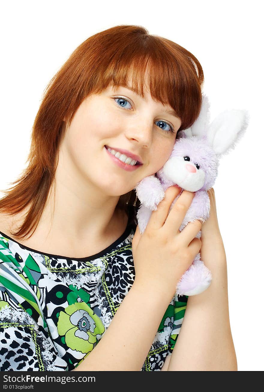 Happy young girl with toy bunny over white