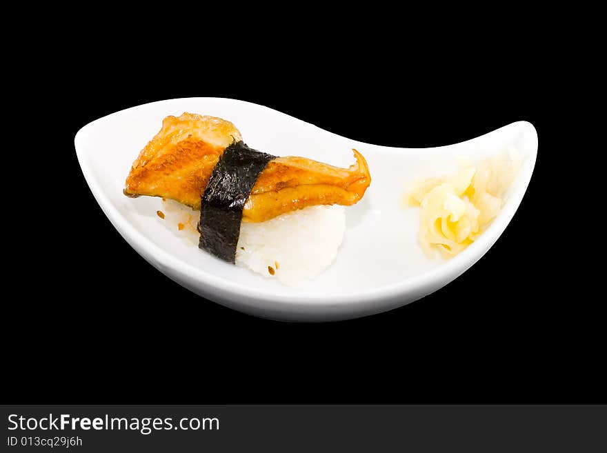 A white plate with a piece of sushi