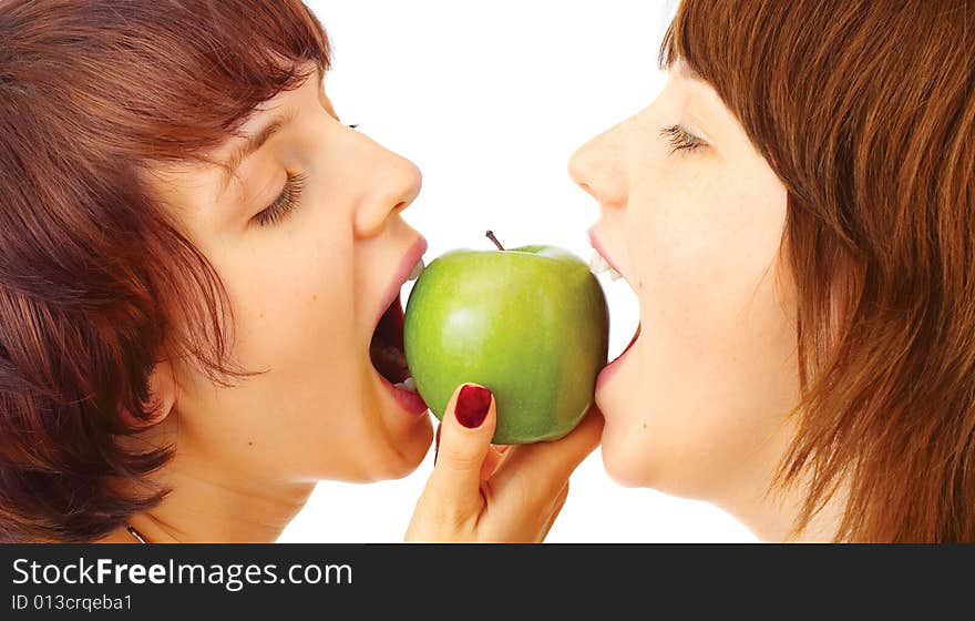 Happy young girls with apple over white