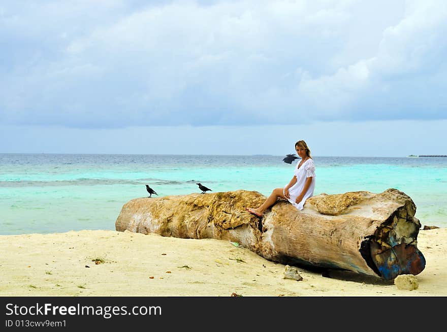 Woman sitting on a log