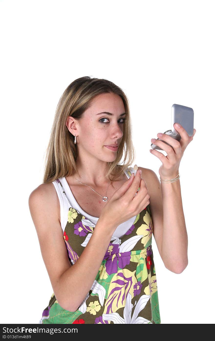 Girl checking her makeup in a mirrored compact