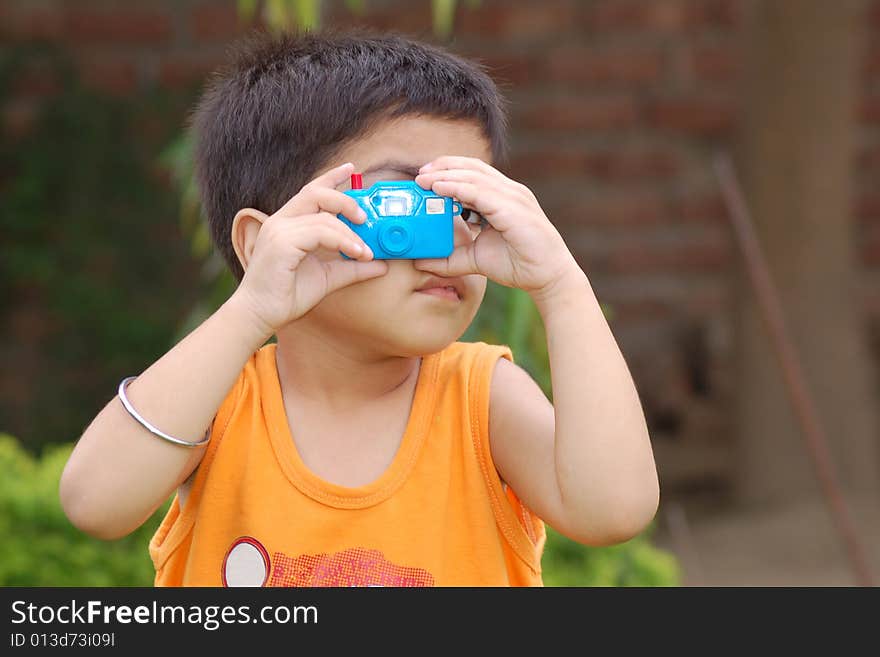 Boy playing with toy Camera