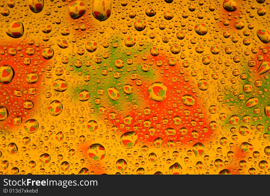 Water drops over strawberries background (close-up photo)