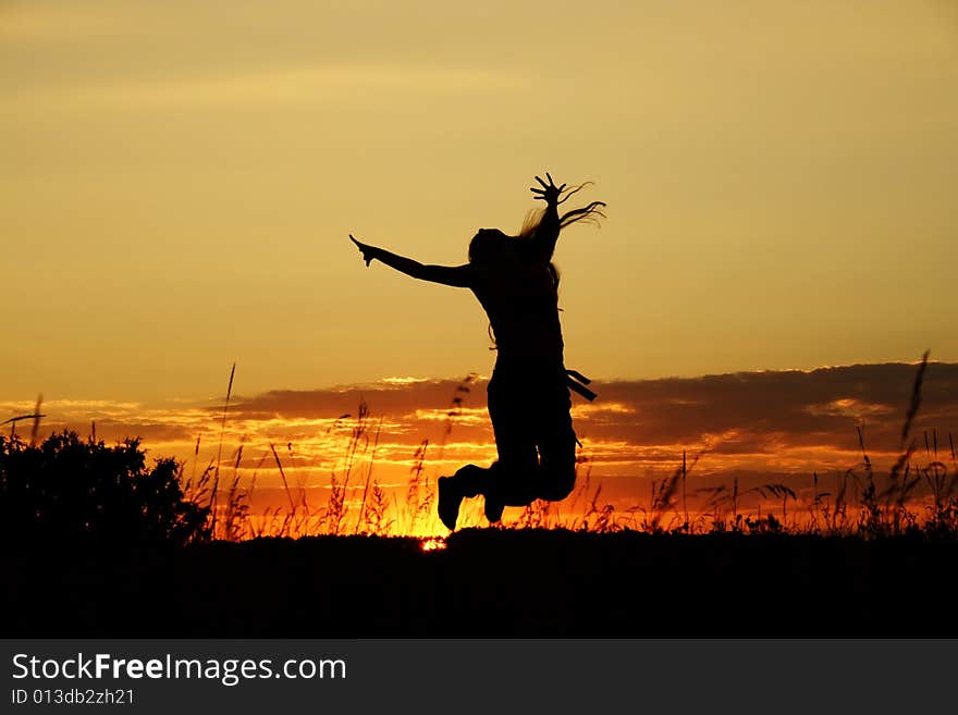 Dark silhouette of the jumping girl