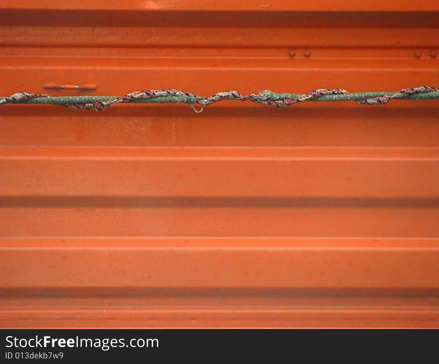 Orange metal texture with rope. Orange metal texture with rope