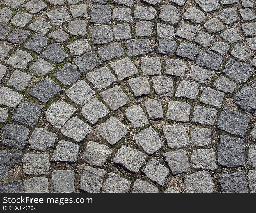 Old cobbled stones pattern road background. Old cobbled stones pattern road background