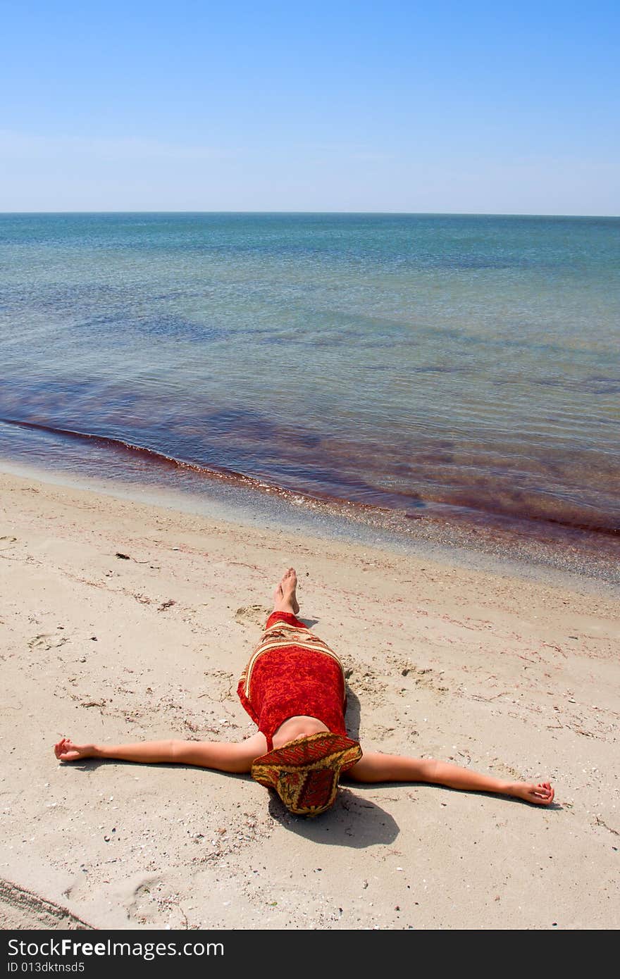 Girl in dress on sea beach