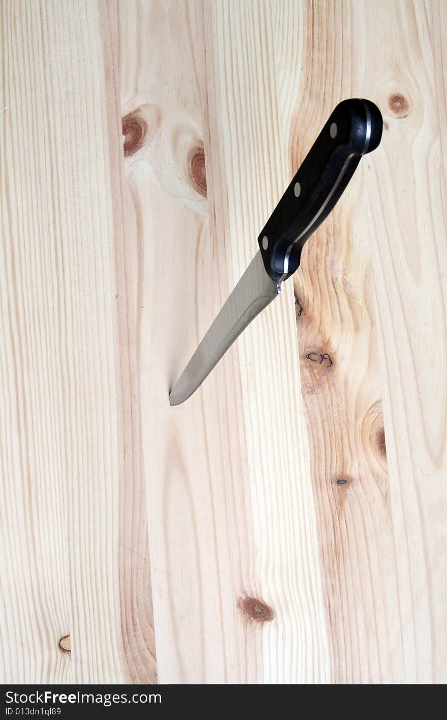 Knife in wooden plate