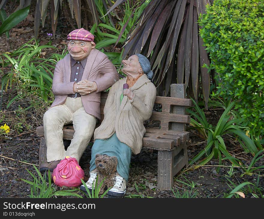 Stone garden ornament of two old tramps. Stone garden ornament of two old tramps