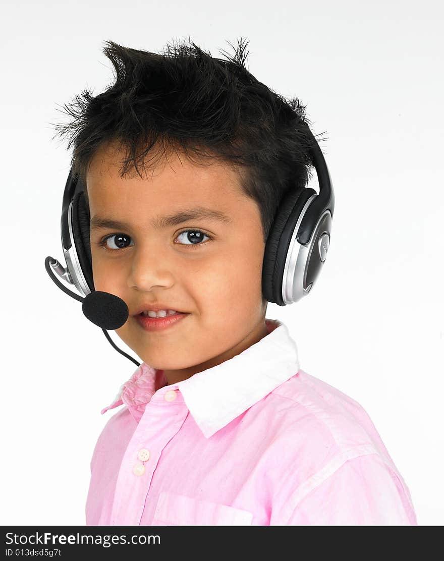 Young Indian boy sitting with headphones on a head. Young Indian boy sitting with headphones on a head