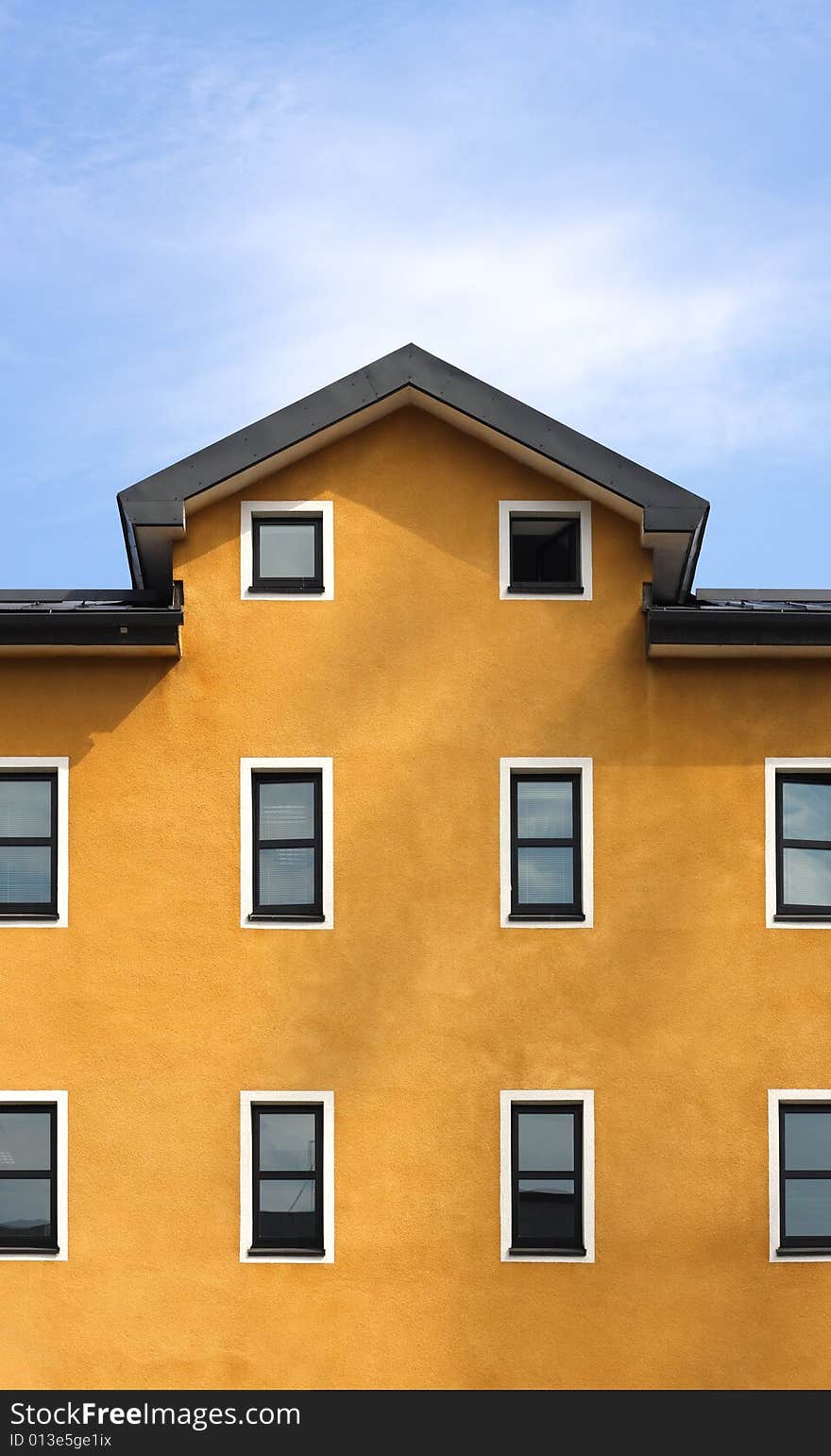 New orange building and blue sky background vertical. New orange building and blue sky background vertical