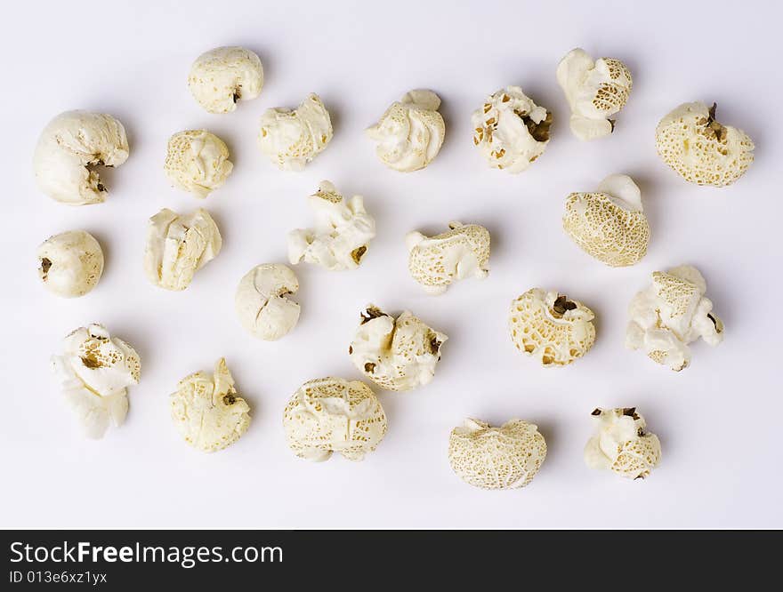 Popcorn grains spilted on white background. Popcorn grains spilted on white background