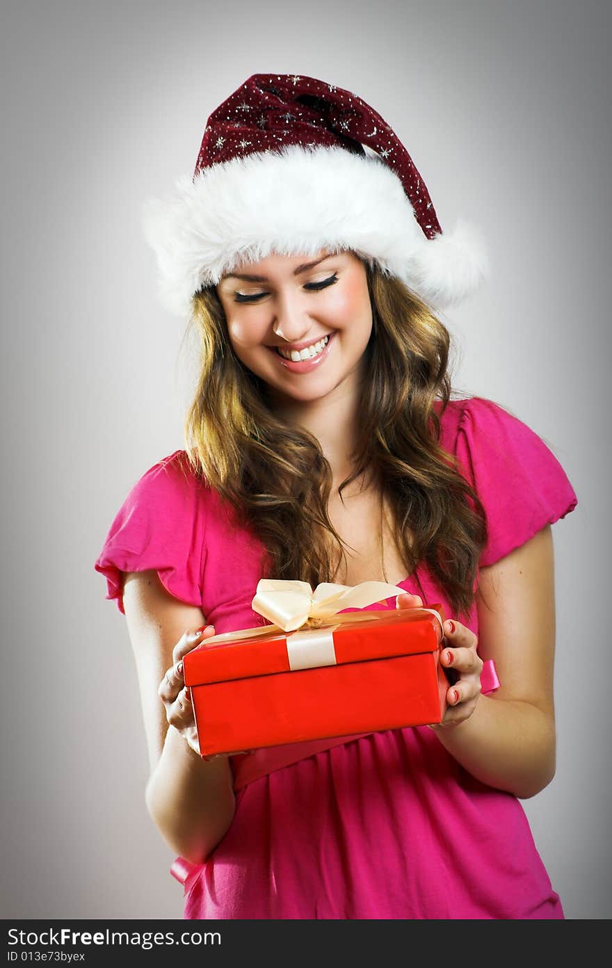 Winter portrait of a beautiful young smiling woman with a christmas cap. Winter portrait of a beautiful young smiling woman with a christmas cap