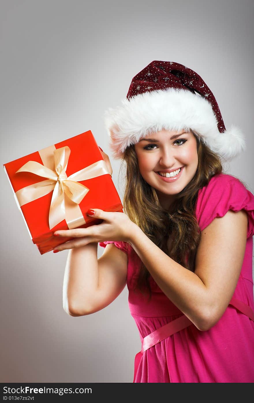 Winter portrait of a beautiful young smiling woman with a christmas cap. Winter portrait of a beautiful young smiling woman with a christmas cap