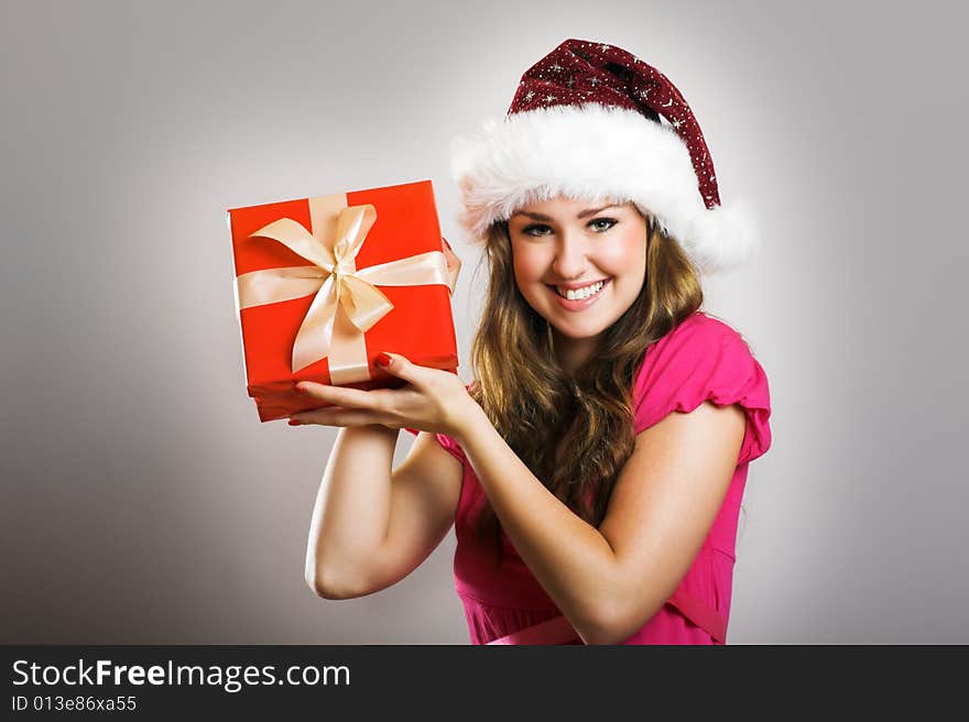 Winter portrait of a beautiful young smiling woman with a christmas cap. Winter portrait of a beautiful young smiling woman with a christmas cap