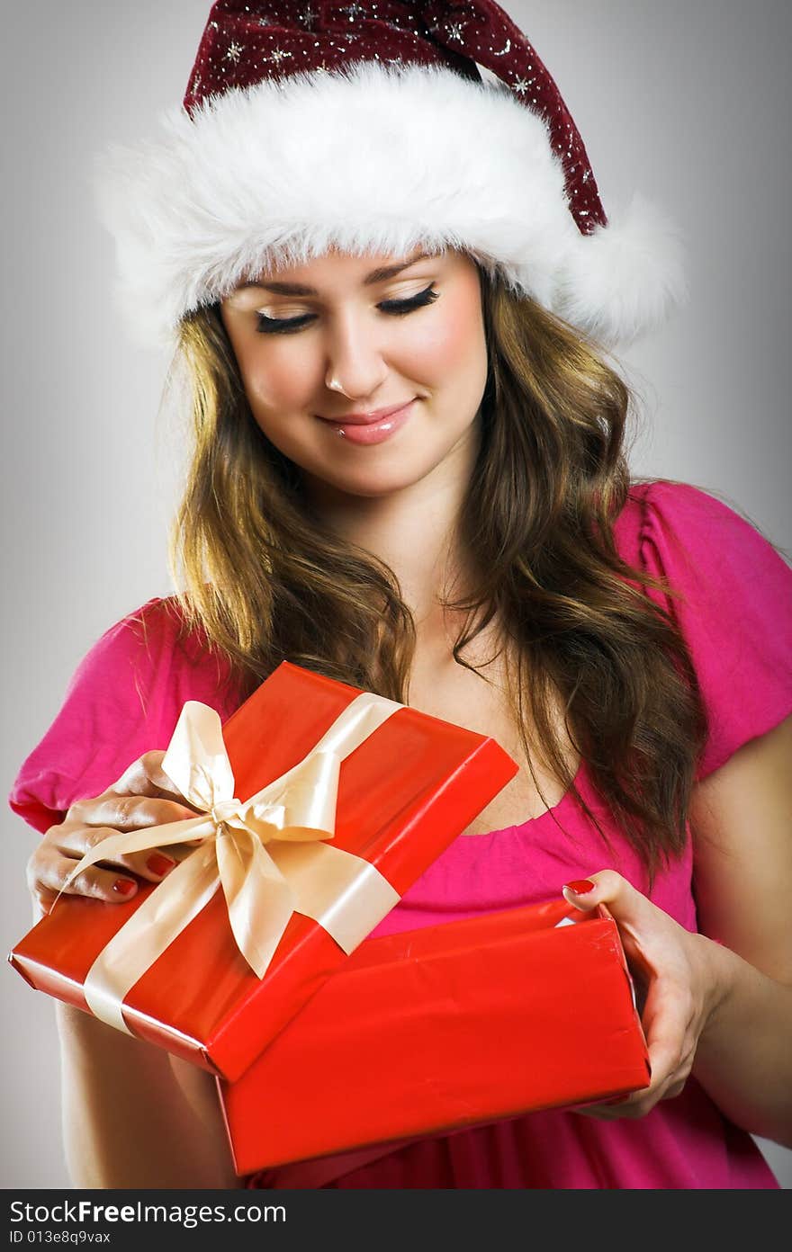 Winter portrait of a beautiful young smiling woman with a christmas cap. Winter portrait of a beautiful young smiling woman with a christmas cap