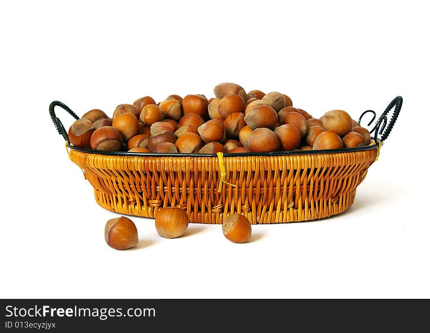 Wood nuts in a basket isolated on a white background