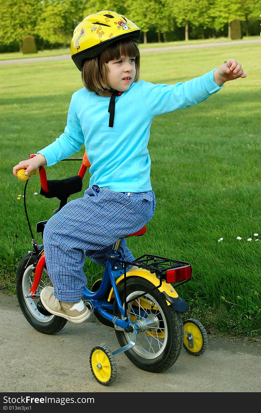 Little girl riding on her bike. Little girl riding on her bike