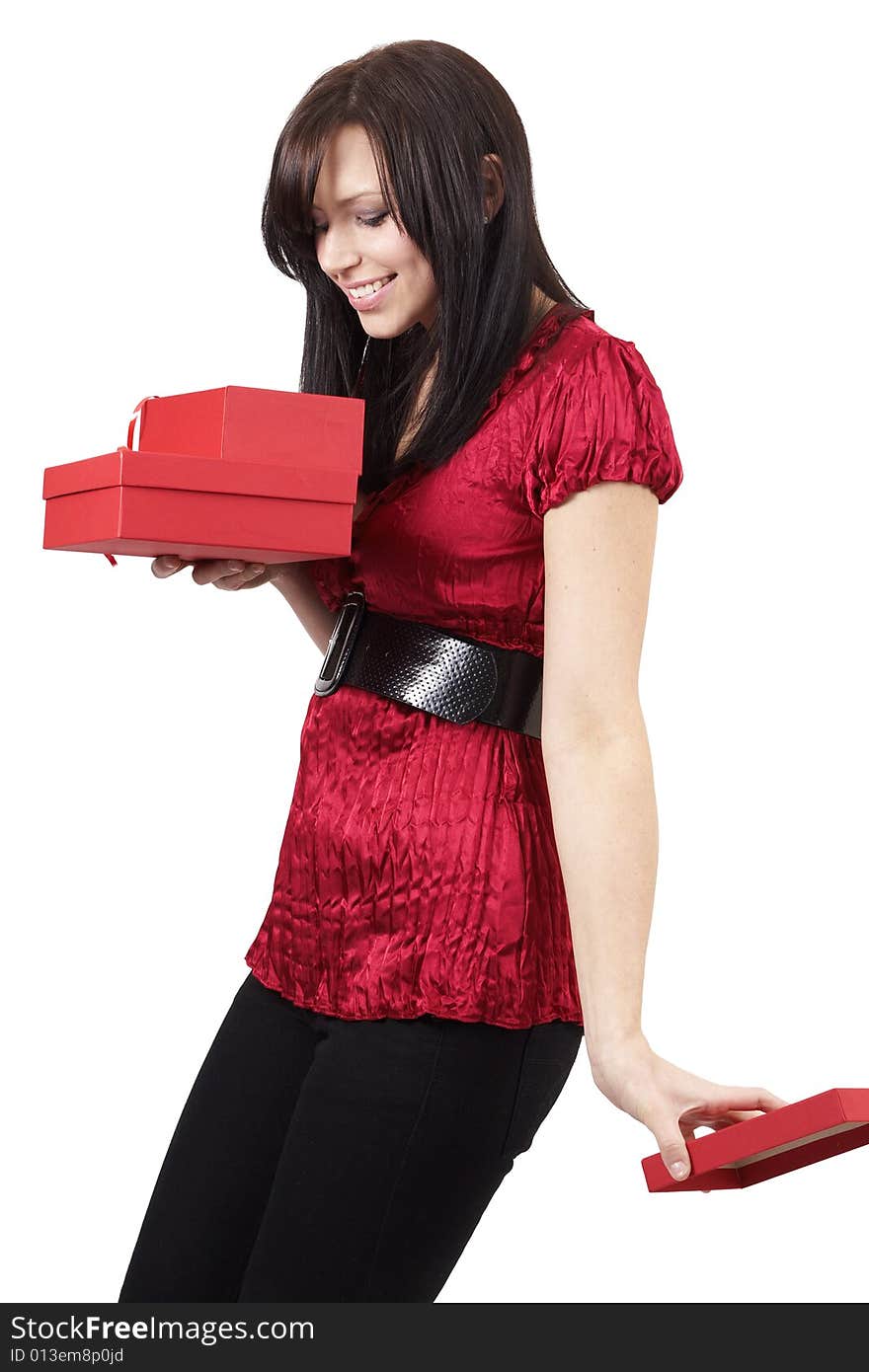 Portrait of a beautiful young brunette woman opening gift boxes at a celebration. Isolated on white background. Portrait of a beautiful young brunette woman opening gift boxes at a celebration. Isolated on white background