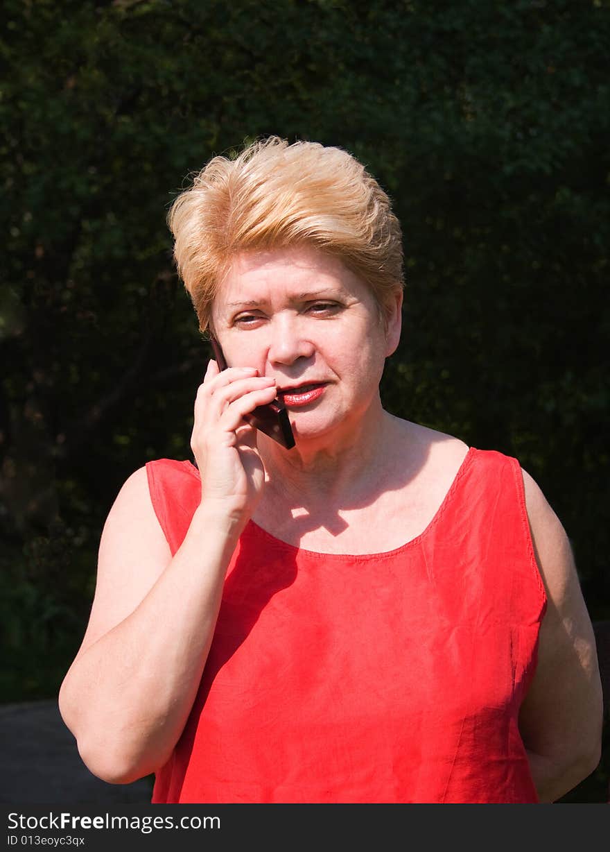 Image of an elderly woman using a mobile phone. Image of an elderly woman using a mobile phone