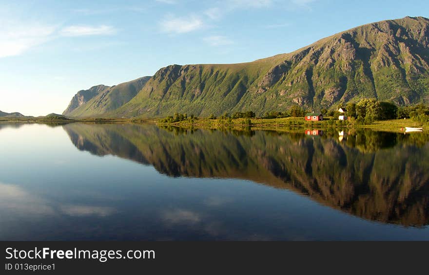 Lofoten's cape mirroring in the fjord