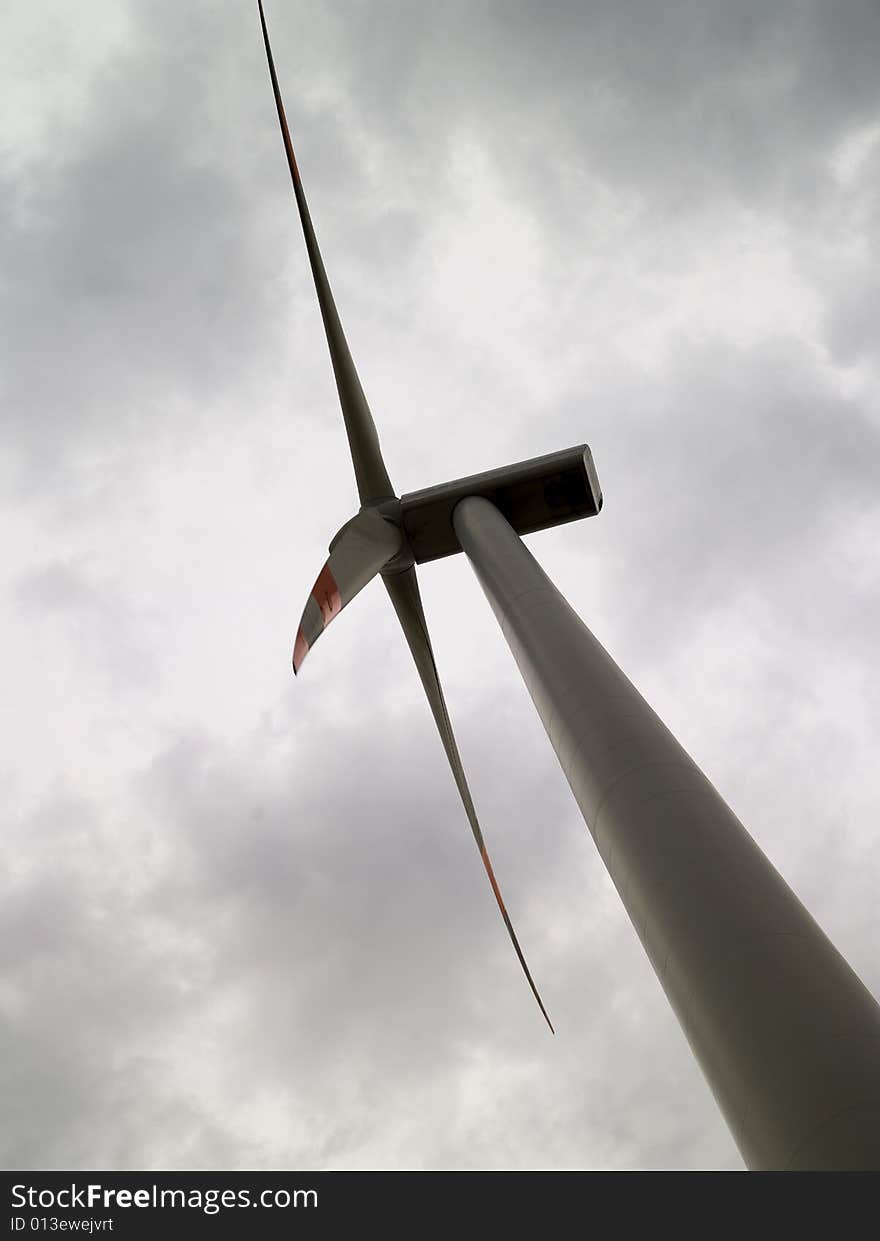 Windmill from frog perspective and clouds in the background